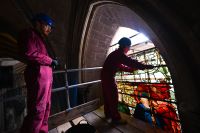 The glazing team remove the upper sections of Angeli Ministrantes in Salisbury Cathedral